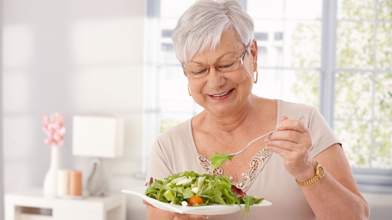 elderly woman eating a healthy meal - Healthy Eating Habits for Aging